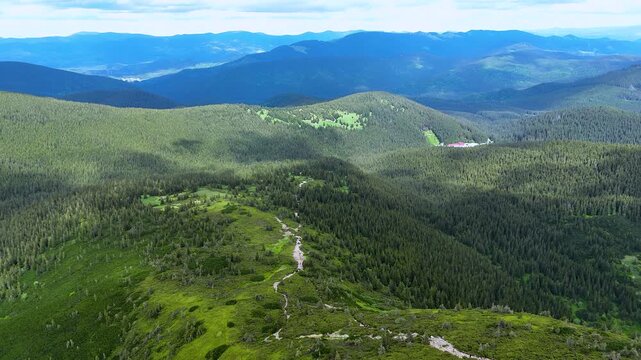 Mass ascent of tourists to Goverla mountain, the highest peak of the Ukrainian Carpathians. Soil erosion around the trail on the mountain slope is a consequence of mass tourism. Concept of travel.