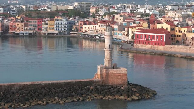  View of Chania with the amazing lighthouse, mosque, venetian shipyards, Crete, Greece.Waves crashing on lighthouse, Beautiful Greece and best scenic places - panorama