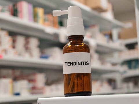 TENDINITIS topical analgesic spray for relief of localized muscle, joint or musculoskeletal pain with pharmacy warehouse drawers in the background