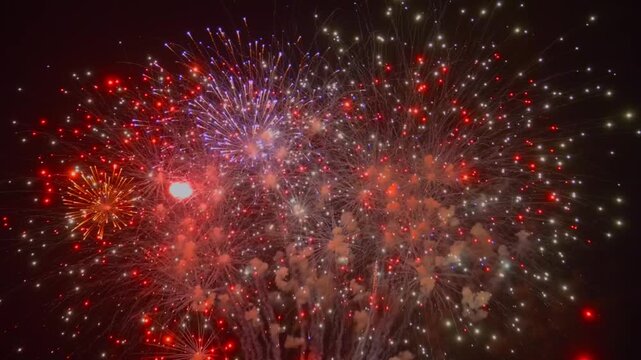 The night sky lights up with colorful fireworks over the city as people gather to celebrate the New Year. The bright bursts fill the air with excitement and joy as the clock strikes twelve.
