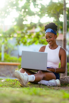 African woman working outdoors on laptop computer