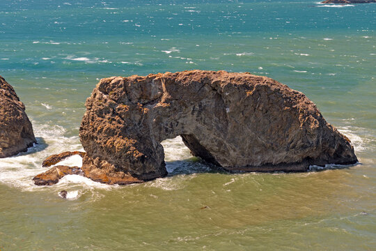 Massive Coastal Arch on Churning Seas