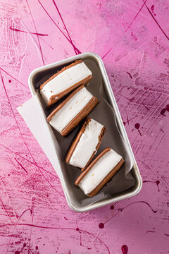 Delicious ice cream sandwiches  on pink table