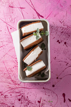 Delicious ice cream sandwiches  on pink table