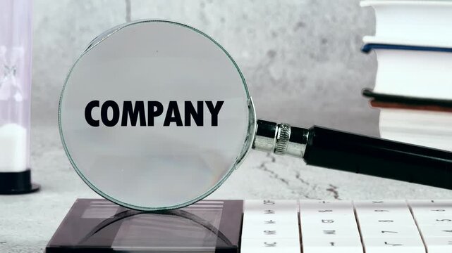 A person looks at the word company through a magnifying glass. The setting includes books and a calendar on a desk. This shows the process of searching for information