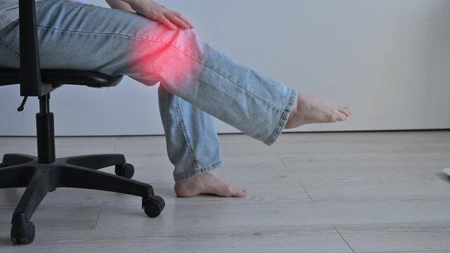 A Caucasian woman suffers from knee pain. The location of the pain is shown as a red spot.