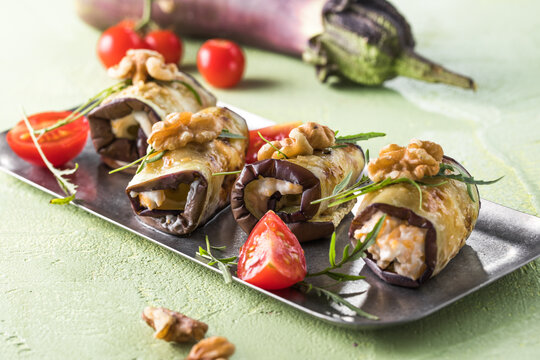 Appetizer - eggplant rolls stuffed with creme cheese, garlic and nuts, tomatoes.