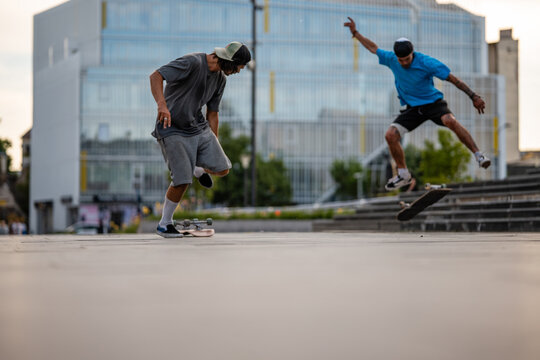 Urban youth performing a skateboard kickflip trick