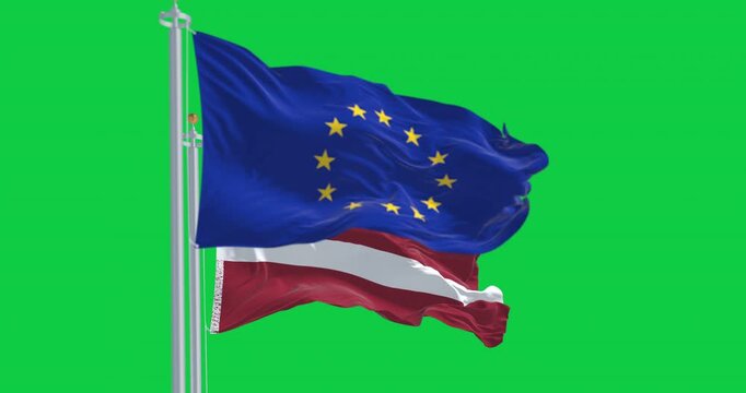 Flags of Latvia and the European Union waving isolated on green background