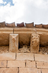 Carved stone corbels and metopes depicting animal heads and floral rosettes under the eaves at the 13th-century Romanesque Church of Natividad de Nuestra Senora in Sotillo, Segovia, Spain © Nandi Estévez