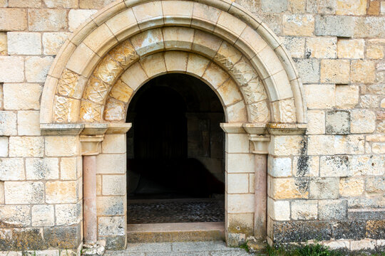 Access portal with decorated semicircular arch and archivolts at the porticoed gallery of the 12th-century Romanesque Church of Nuestra Senora de la Asuncion in Duraton, Sepulveda, Segovia, Spain