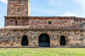 Exterior view of the 12th century Romanesque church of San Martin de Tours featuring a porticoed gallery with round arches, carved capitals, and ashlar masonry, located in Vizcainos de la Sierra,Spain © Nandi Estévez