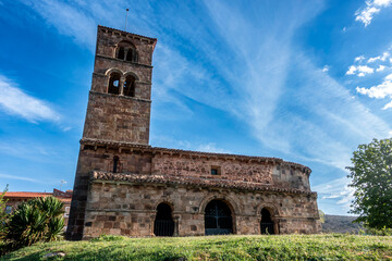 Exterior view of the late 12th century Romanesque church of San Martin de Tours featuring a porticoed gallery and a tall square bell tower, located in Vizcainos de la Sierra, Burgos, Castilla y Leon,  © Nandi Estévez