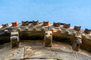 Carved stone corbels displaying barrel geometric forms and animal figures under the eaves of the 12th century Romanesque apse of San Martin de Tours church, located in Vizcainos, Burgos, Spain © Nandi Estévez