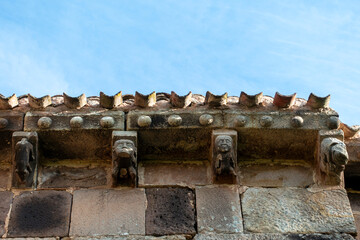 Carved stone corbels displaying human heads and animal figures under the eaves of the 12th century Romanesque church of San Martin de Tours, located in Vizcainos, Burgos, Castilla y Leon, Spain © Nandi Estévez
