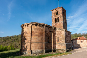 Romanesque church of San Martin de Tours, 12th century ashlar stone temple featuring a semicircular apse with corbels and a square bell tower, located in Vizcainos de la Sierra, Burgos, Spain © Nandi Estévez
