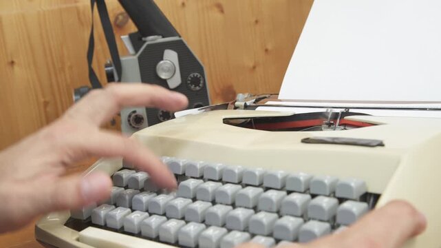 vintage mechanical typewriter mid-action, featuring the word "SCREENPLAY" typed onto a blank white sheet of paper. The detailed mechanism shows the vintage cinema and filmmaking concept.