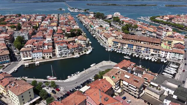 Drone footage over Canale Mandracchio harbor in Grado, Italy
