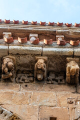 Detail of carved stone corbels and metopes above the portal archivolts of the Collegiate Church of San Pedro in Cervatos, Campoo de Enmedio, Cantabria, Spain, Romanesque architecture from the 12th © Nandi Estévez