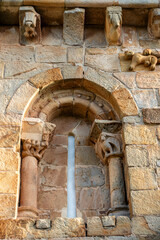 Detail of the Romanesque window with splayed arch and sculpted capitals on the facade of the Church of San Cipriano in Bolmir, Campoo de Enmedio, Cantabria, Spain, 12th century © Nandi Estévez