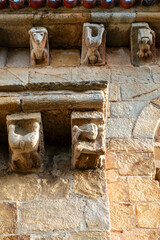 Detail of carved stone corbels under the roof eaves of the Church of San Cipriano in Bolmir, Campoo de Enmedio, Cantabria, Spain, Romanesque architecture from the 12th century © Nandi Estévez