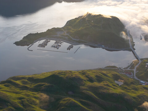 Aerial view of the marina and surrounding green hills in Unalaska, Alaska, United States.