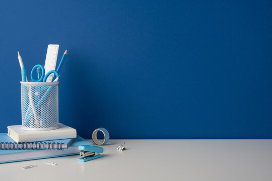 Side view photo of blue stationery and school supplies on a clean desk for back to school study