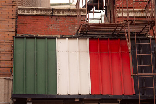 Italian Flag Colors on Urban Building Facade with Fire Escape in New York City