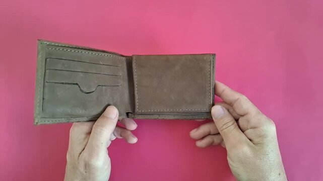 Brown leather wallet opening motion in high quality video footage