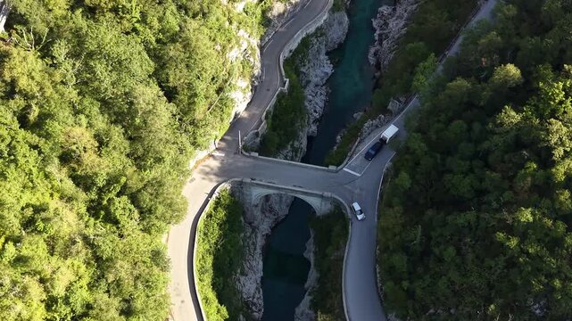 Drone shot of cars crossing Napoleon's Bridge over Soca river, Slovenia