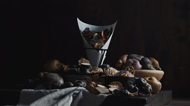 Assorted native Peruvian potatoes and purple chips in a rustic setting.