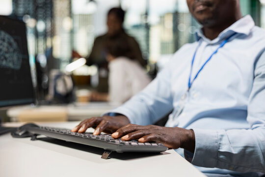 Close-up of an engineer using AI scripts on a computer shows repetitive task automation and faster feature implementation with artificial intelligence technology in a startup office.