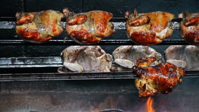 Rows of Authentic Peruvian Rotisserie Chicken Roasting on a Spit