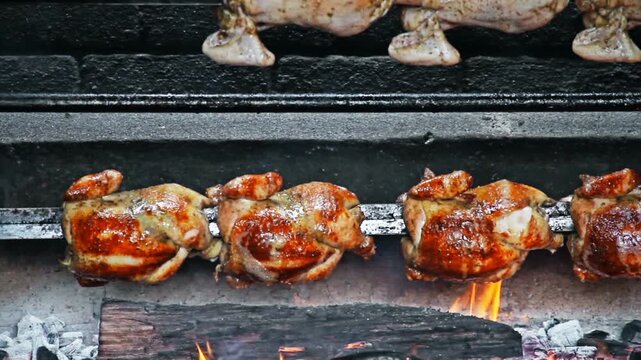 Rows of Authentic Peruvian Rotisserie Chicken Roasting on a Spit