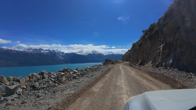 Driving Along Gravel Road Beside Lago General Carrera Toward Chile Chico In Patagonia Chile With Snow Capped Andes