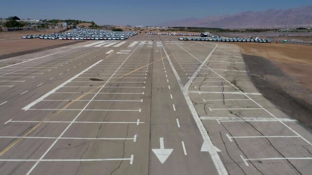 Aerial view of airport parking lot with organized vehicle rows
