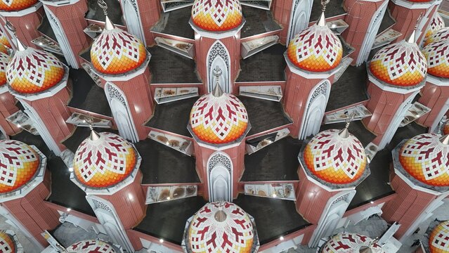 Aerial view of Masjid Kubah 99 Asmaul Husna featuring numerous colorful domes with intricate geometric patterns in Kecamatan Mariso, Sulawesi Selatan, Indonesia.