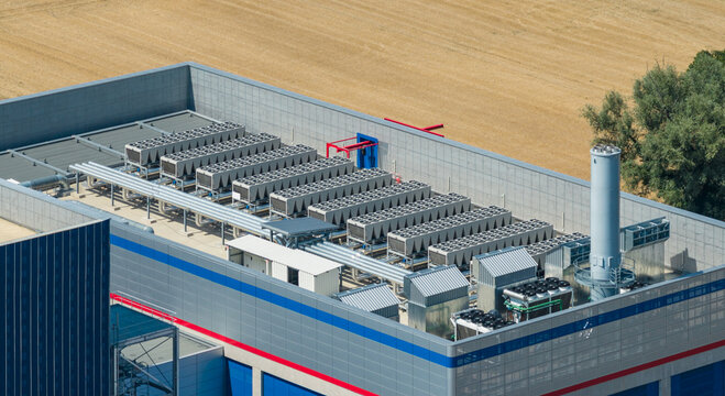 Aerial view of rooftop cooling systems, industrial heat exchangers, and ventilation units at the STMicroelectronics semiconductor manufacturing facility in Crolles, Auvergne-Rhone-Alpes, France.