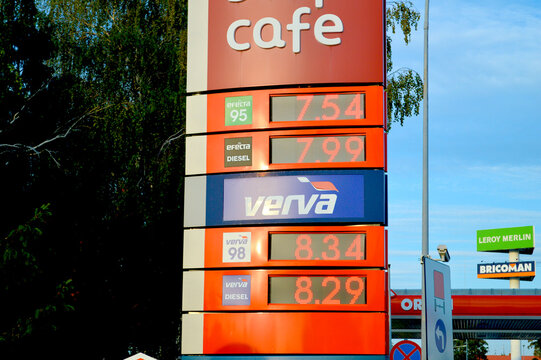 Orlen gas station fuel price display sign showing Verva and Efecta gasoline and diesel prices outdoors under bright blue sky