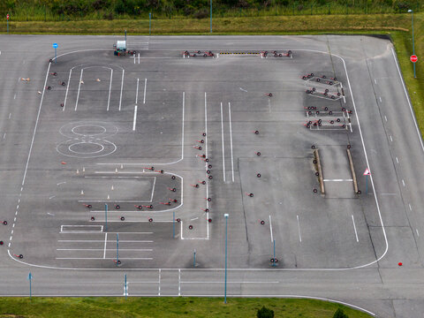 Aerial view of a driving school training course with marked lanes, traffic cones, and parking practice areas in Vilnius, Vilniaus apskritis, Lithuania.