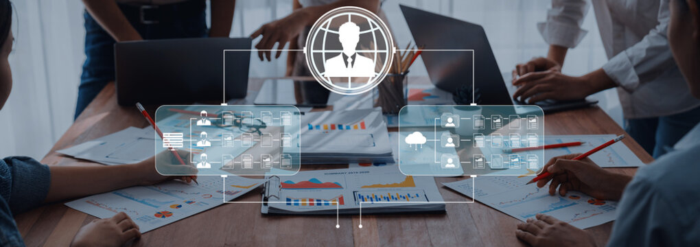 Collaborative Business Meeting with Data Analysis and Digital Strategy Implementation in Modern Office Environment. Sentient.