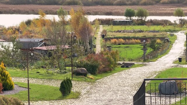 Curved park paths surrounded by green lawns and autumn trees. Soft natural colors and quiet outdoor mood. Concept: mindful walking, seasonal transitions, calm outdoors.