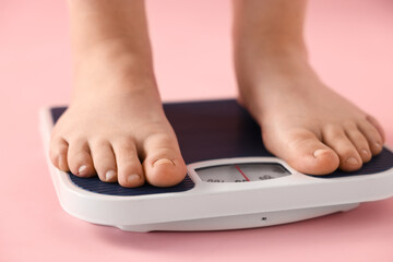 Fototapeta premium Overweight woman on scale against pink background, closeup