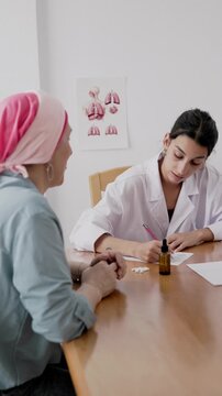 Female doctor prescribing cbd oil for senior cancer patient