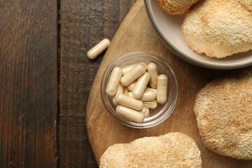 Functional mushrooms and pills on wooden table, top view. Space for text © New Africa