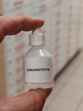 CONJUNCTIVITIS inflammatory condition of the conjunctiva requiring cause-specific ophthalmic care with pharmacy drawers in the background