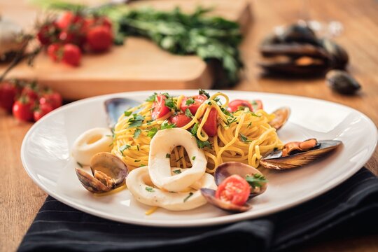 Artisan pasta tossed with succulent seafood and vibrant tomatoes creating a Mediterranean culinary experience that celebrates authentic coastal flavors and healthy dining