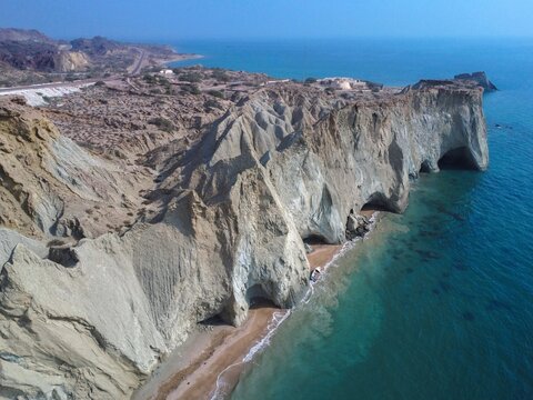 Aerial view of coastal cliffs towering above a sandy beach, Turtle Beach, Hormuz Island, Iran