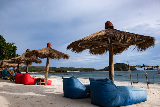 Sun umbrellas and sun loungers on Tanjung Aan Beach, Lombok, Indonesia