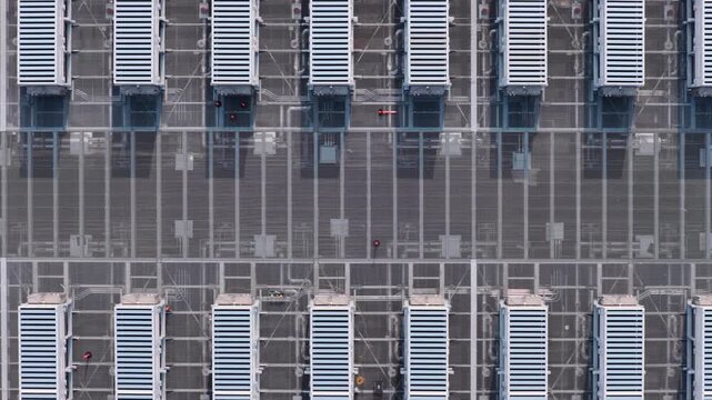 Aerial view of a data center with rows of server cooling units on a paved lot in Illinois, United States.
